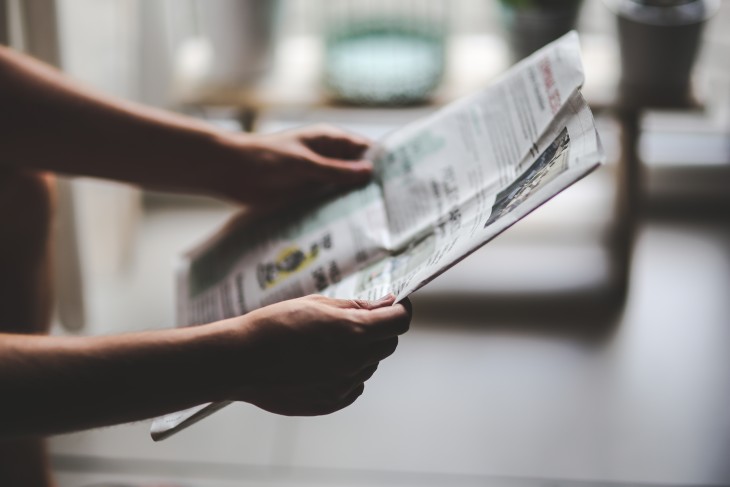 Person reading newspaper